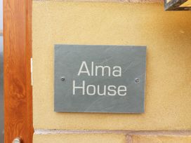 A name plate on a wall for Alma House in Seahouses