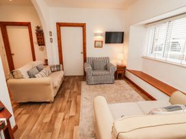 A living room with two sofas and a television at Spinnaker