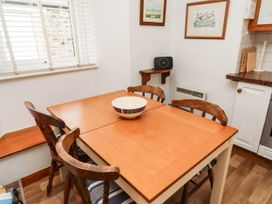 A dining room with a table and chairs at Spinnaker