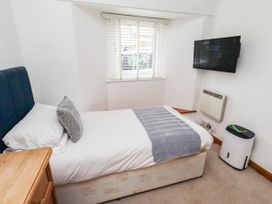 A bedroom with a bed and a television at Spinnaker 