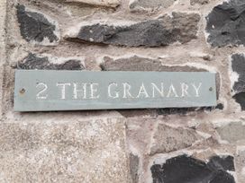 A sign that reads '2 THE GRANARY' attached to a stone wall at Spinnaker