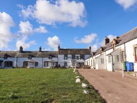 A row of houses along a driveway with grass in front at Spinnaker