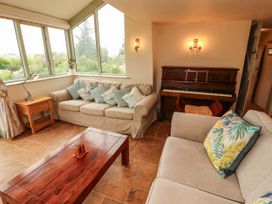 A living room with a sofa and piano at Claybottom Farm near Hesket Newmarket