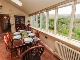 A dining room with a table set for meals at Claybottom Farm near Hesket Newmarket