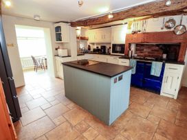 A kitchen with a blue cooker and island at Claybottom Farm near Hesket Newmarket