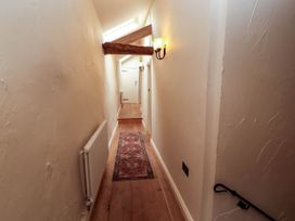 A hallway with a rug and light fixture at Claybottom Farm near Hesket Newmarket