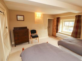A bedroom with beds and furniture at Claybottom Farm near Hesket Newmarket