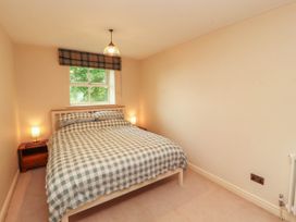 A bedroom with a bed and bedside tables at Claybottom Farm near Hesket Newmarket
