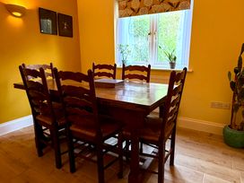 A dining room with a table and chairs at Fables Cottage in Otley, Suffolk