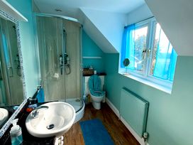 A bathroom with a shower, toilet, and sink at Fables Cottage Otley, Suffolk