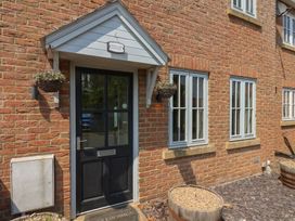An entrance with a front door and windows at Over Carr Cottage in Malton