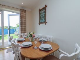 A dining room with a table set for meals at The Cosy Haven in Malton