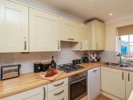 A kitchen with cabinets and appliances at The Cosy Haven in Malton