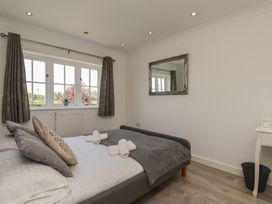 A bedroom with a bed and window at The Cosy Haven in Malton