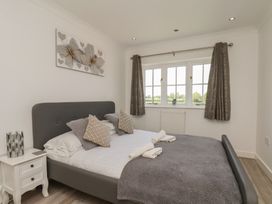A bedroom with a bed and window at The Cosy Haven in Malton