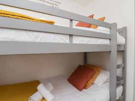 A bunk bed with pillows and towels at The Cosy Haven in Malton