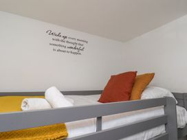 A bedroom with a bed and decorative pillows at The Cosy Haven in Malton