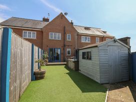 A garden with a house and a shed at The Cosy Haven in Malton