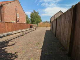 An outdoor space with a paved area and wooden fence at The Cosy Haven in Malton