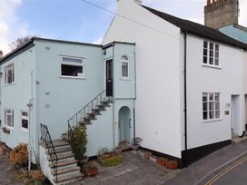 An exterior view of a building with stairs and planters at 2 Mill Green Court Lyme Regis