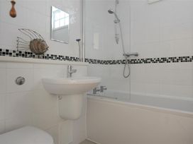 A bathroom with a shower and bathtub at 2 Mill Green Court in Lyme Regis