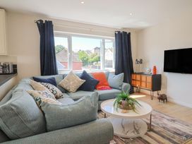 A living room with a sofa and coffee table at 2 Mill Green Court in Lyme Regis