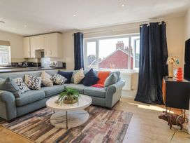 A living room with a sofa and coffee table at 2 Mill Green Court in Lyme Regis