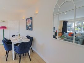 A dining room with a table set for dinner at 2 Mill Green Court in Lyme Regis