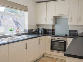 A kitchen with cabinets, sink, and oven at 2 Mill Green Court in Lyme Regis