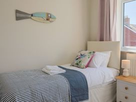 A bedroom with a single bed and lamp at 2 Mill Green Court in Lyme Regis