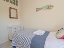 A bedroom with a bed and dresser at 2 Mill Green Court Lyme Regis