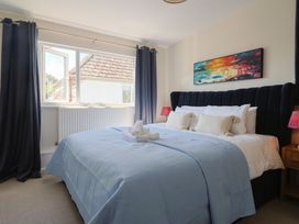 A bedroom with a bed and window at 2 Mill Green Court in Lyme Regis
