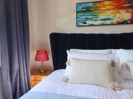 A bedroom with a bed and bedside lamp at 2 Mill Green Court in Lyme Regis