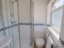 A bathroom with a shower and toilet at 2 Mill Green Court Lyme Regis