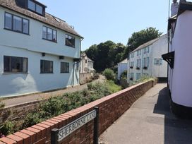 A street view featuring houses and a brick wall at 2 Mill Green Court in Lyme Regis