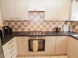 A kitchen with appliances and counter space at 7 Cwrt Y Cadno in Llantwit Major