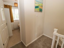 A hallway with a staircase and door at 7 Cwrt Y Cadno Llantwit Major