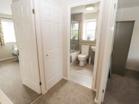 A bathroom with a bathtub, toilet, and sink at 7 Cwrt Y Cadno, Llantwit Major