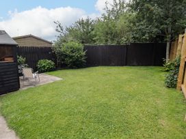 A garden with grass and a shed at 7 Cwrt Y Cadno in Llantwit Major