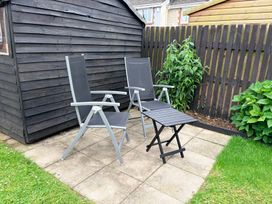 A garden area with chairs and a shed at 7 Cwrt Y Cadno Llantwit Major