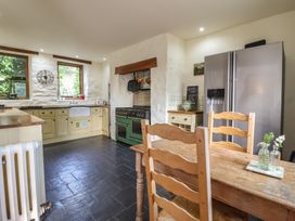 A kitchen with a refrigerator and cooking range at Pandy Farmhouse