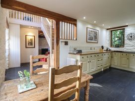 A kitchen with a table and chairs at Pandy Farmhouse
