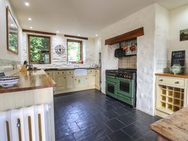 A kitchen with cooking range and sink at Pandy Farmhouse