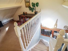 A staircase view with a desk and plant at Pandy Farmhouse