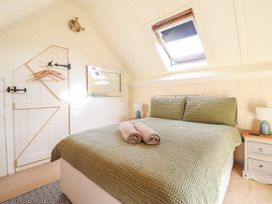 A bedroom with a bed and towels at Pandy Farmhouse