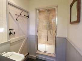 A bathroom with a shower and bathtub at Pandy Farmhouse
