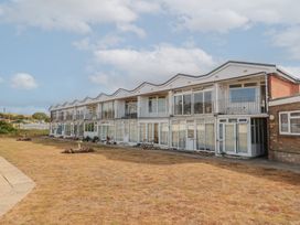 A building with balconies and windows at 4 Kingfisher Court in West Bay