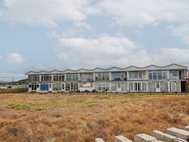 A building with multiple windows at 4 Kingfisher Court in West Bay