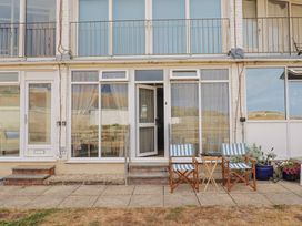 An outdoor area with chairs and a table at 4 Kingfisher Court in West Bay