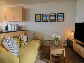 A living room with a sofa and coffee table at 4 Kingfisher Court in West Bay
